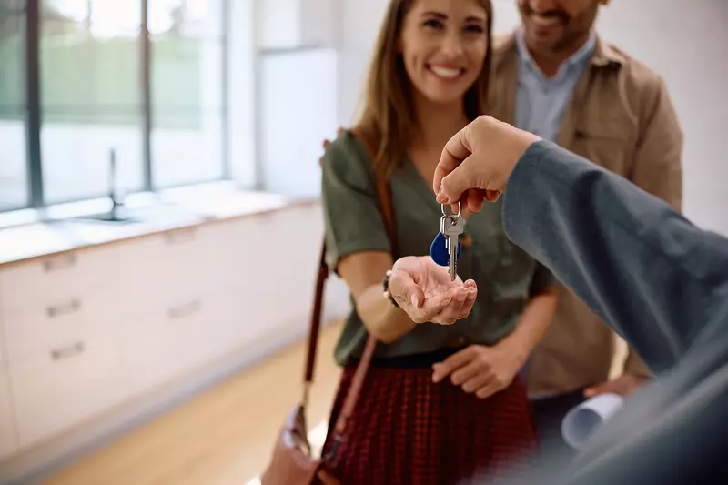 realtor handing keys to new owners