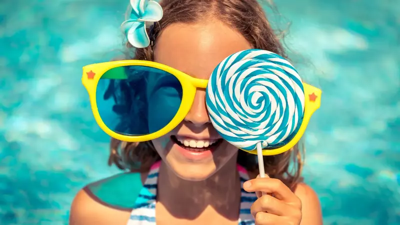 Image header girl wearing oversized yellow sunglasses and big blue and white lollipop. 5 Seriously Fun Summer Activities in Park City