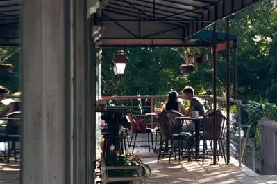 Couple dining in at a Park City restaurant on the wooded balcony