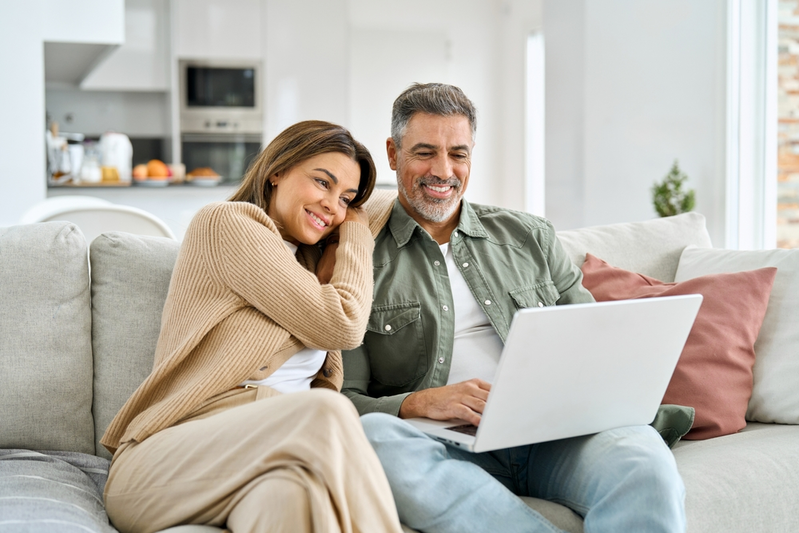 husband and wife looking at laptop