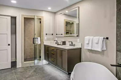 Primary En Suite Bathroom in Golden Aspen at Westgate Park City with quartz vanity, LED mirror, and black fixtures. Spa finishes in Canyons.