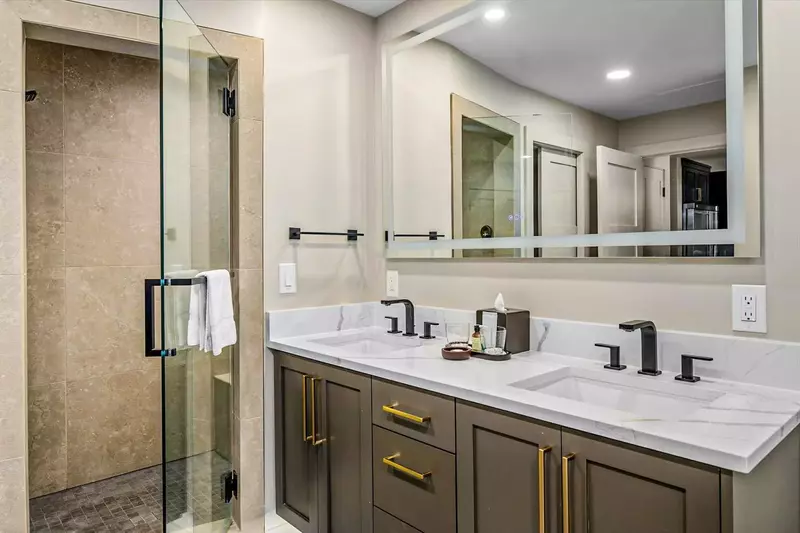 En Suite Primary Bathroom in Golden Aspen at Westgate Park City with double quartz vanity, LED back lit mirrors, Steam shower, and Soaking tub.