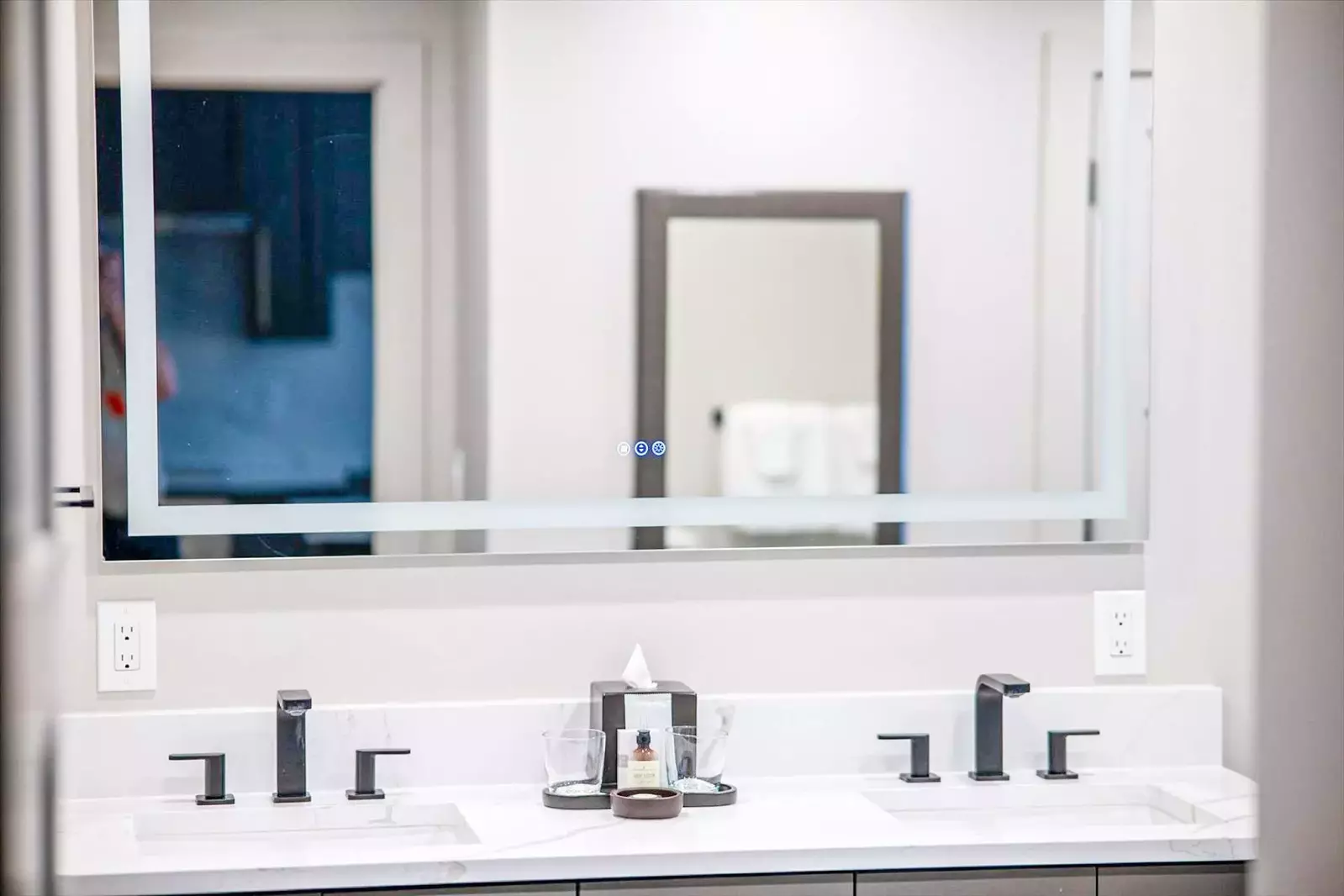 Primary en suite bathroom features a quartz double vanity with LED back-lit mirrors, soaking tub, walk in glass steam shower, and high-end finishes