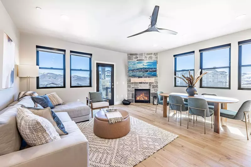 Enjoy these wrap around views in the modern living room with a gas fireplace, large HDTV, and comfortable sofa.