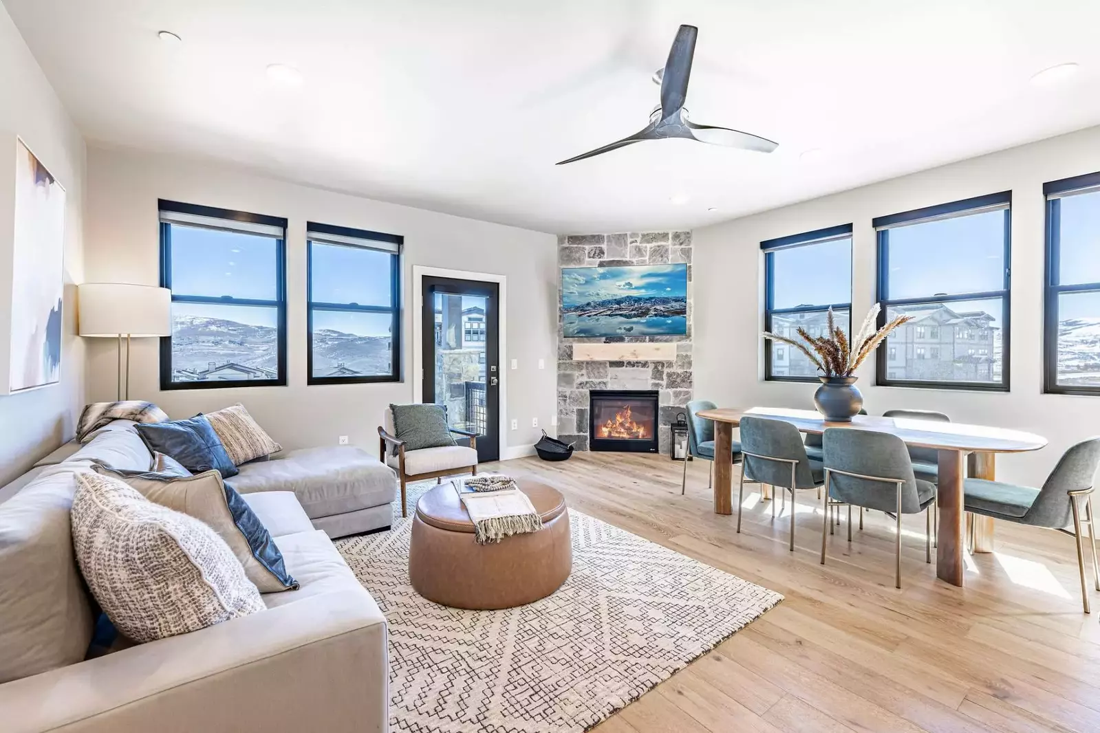 Enjoy these wrap around views in the modern living room with a gas fireplace, large HDTV, and comfortable sofa.
