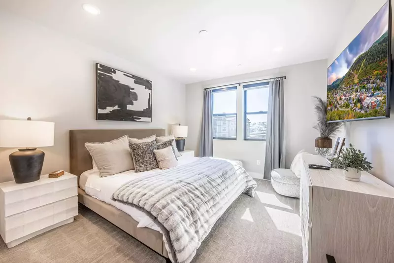 Another king sized bed is featured in thsi spacious bedroom along with 2 nightstands and private tv