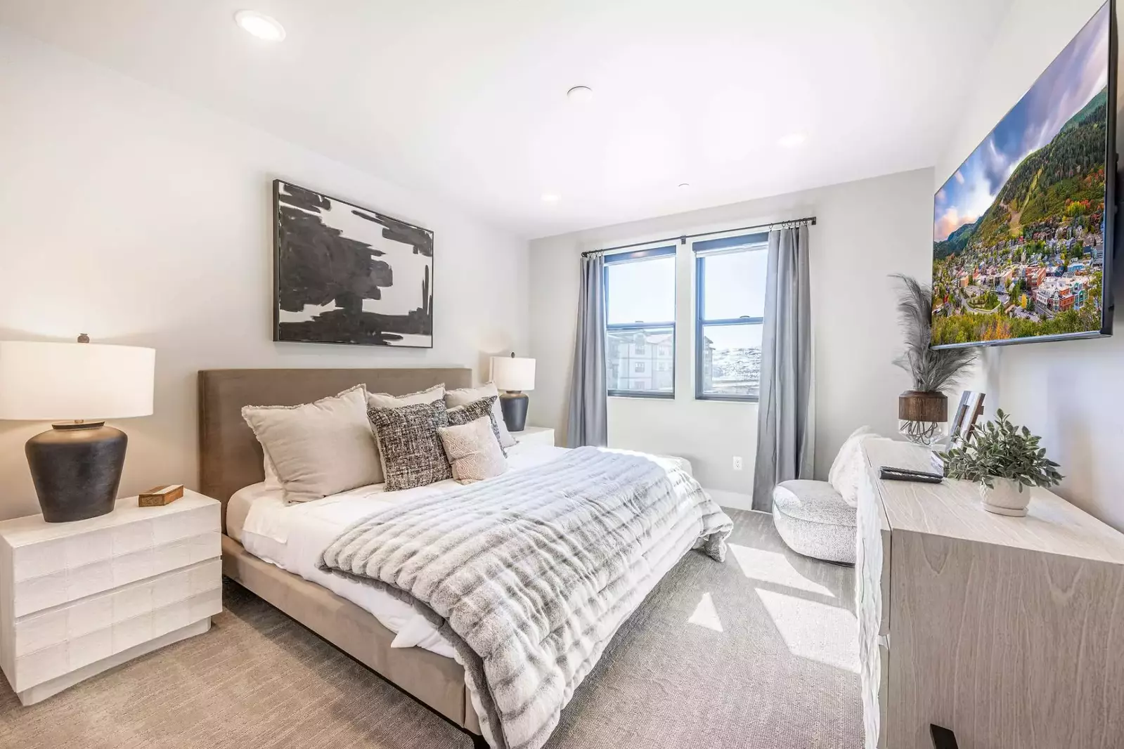 Another king sized bed is featured in thsi spacious bedroom along with 2 nightstands and private tv