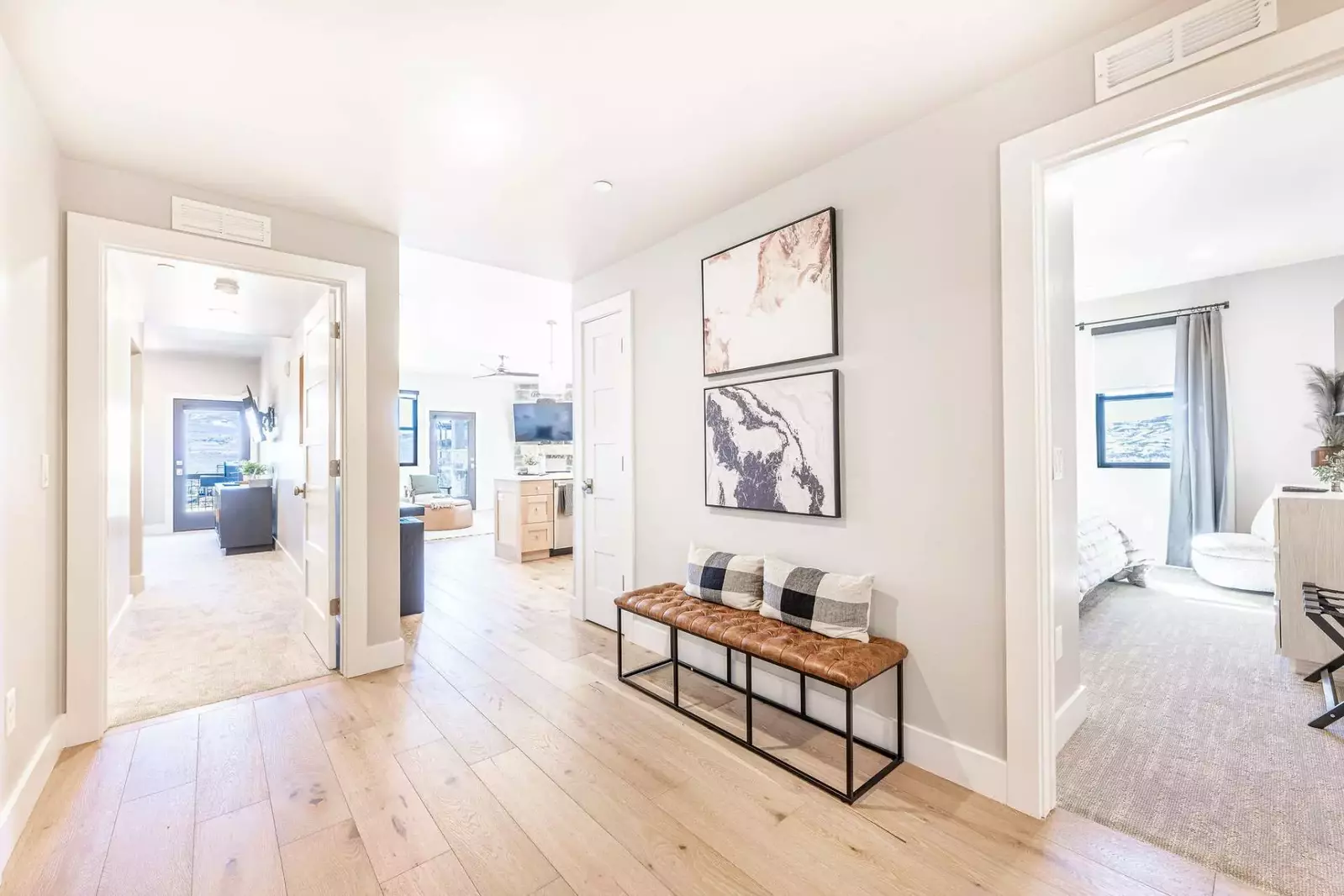 The airy entry way welcome guests to this modern home with a comfortable bench