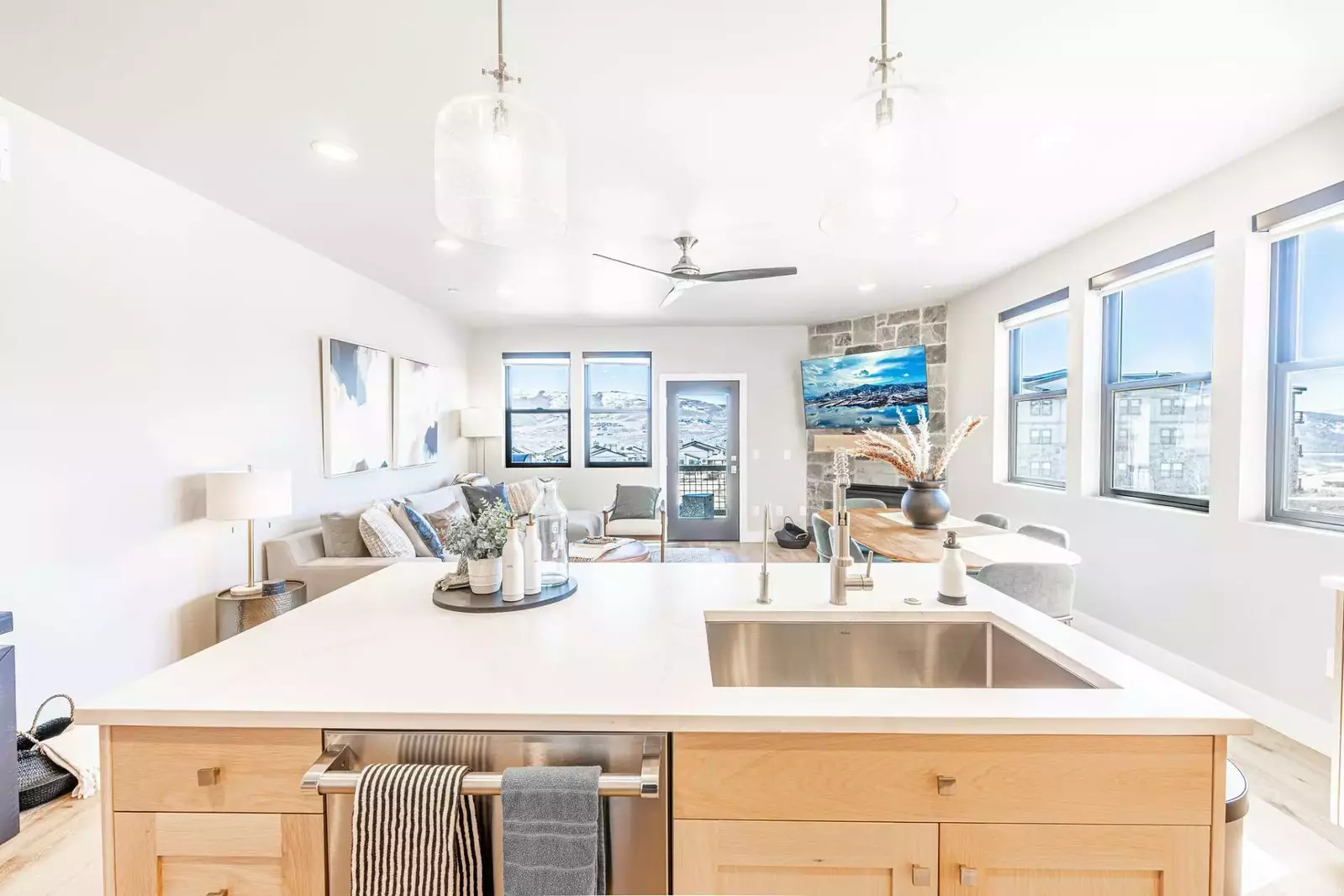 The oversized kitchen island has space for 2 guests to eat at the breakfast bar and is open to the main living room of the home