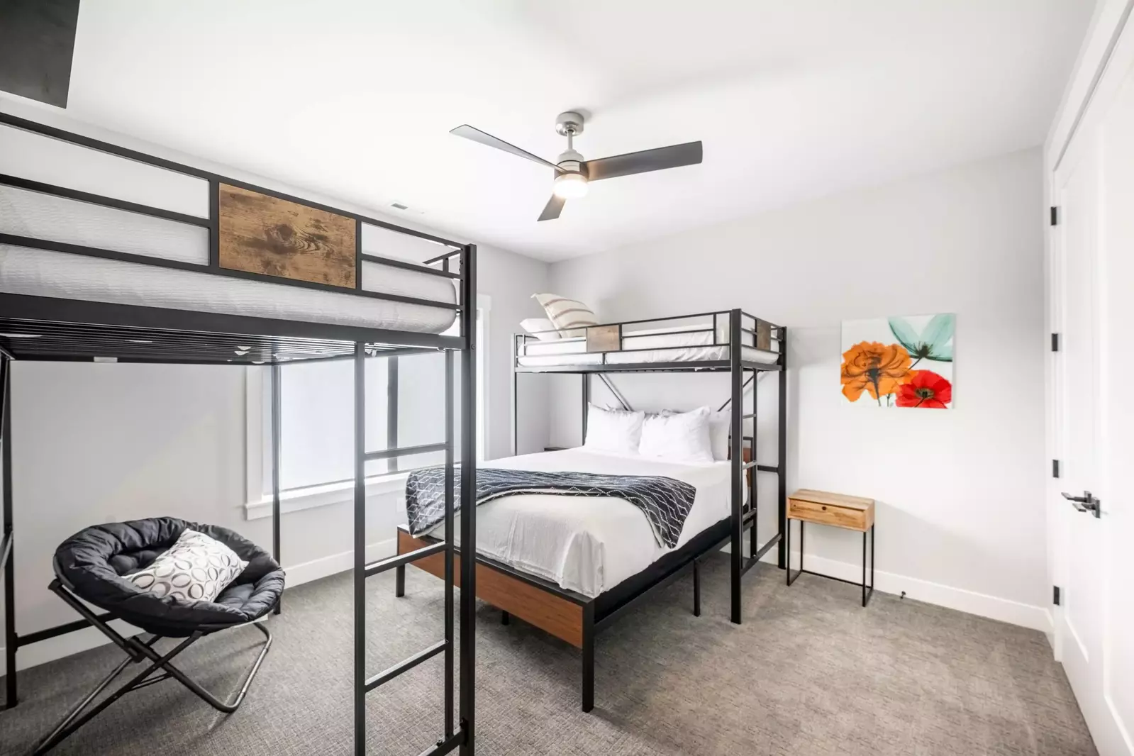 The upstairs guest suite features a twin sized bunk bed over a full sized bed. In addition there is a queen sized loft bed in this room