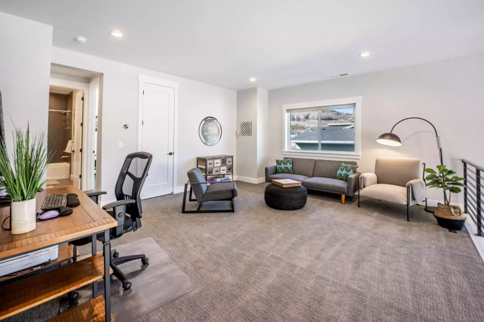 The upstairs loft features a futon sleeper sofa and a comfortable work from home space with a large desk and comfortable chair