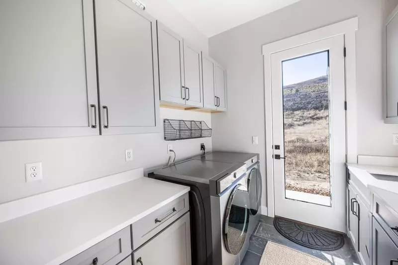 The private laundry room has a large washer and dryer for guest use and leads right to the private hot tub