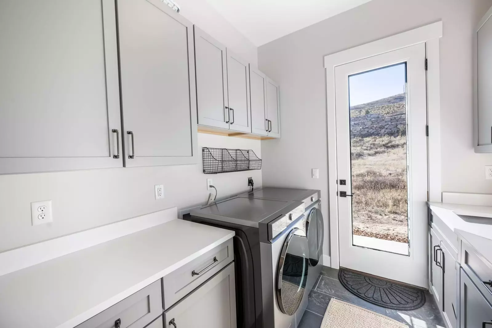 The private laundry room has a large washer and dryer for guest use and leads right to the private hot tub