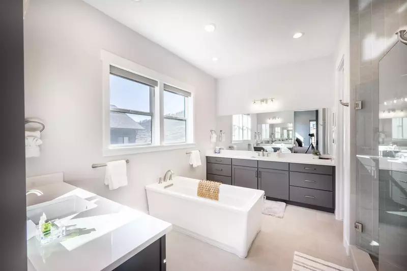 Relax in the luxurious primary ensuite oversized soaker tub which also offers 2 large sinks and vanities, and a walk in shower