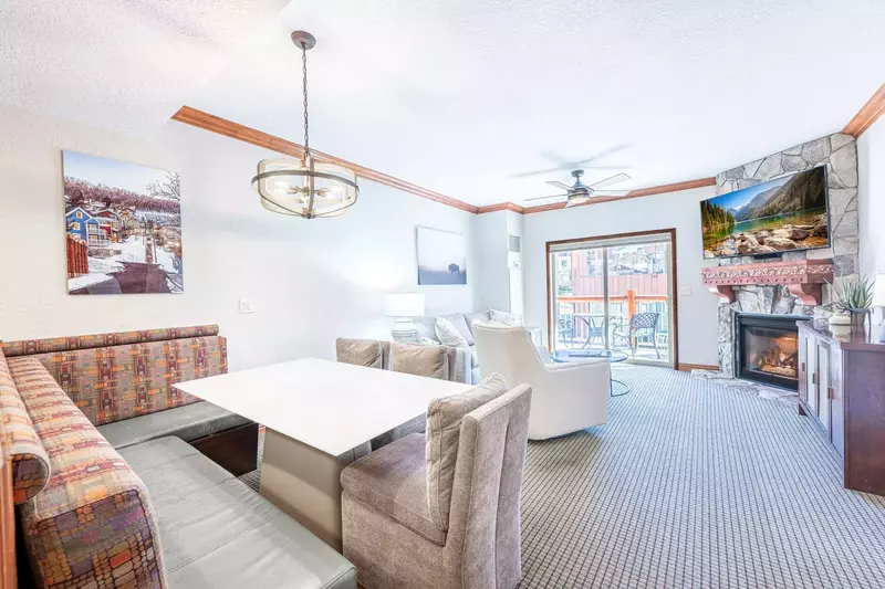 Step inside this beautiful and roomy living room adorned with games, a cozy queen sleeper sofa, and warm gas fireplace.