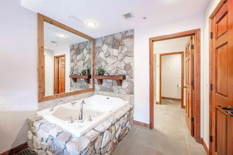 Unwind in the spacious en suite jetted tub, thoughtfully designed separate from the bathroom to accommodate the leisurely preparations of two guests