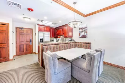 The spacious dining area provides ample seating with a stylish dining bench and two comfortable dining chairs.