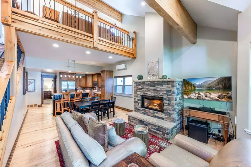 Valuted ceiling living room provides comfortable seating for gathering around the gas fireplace
