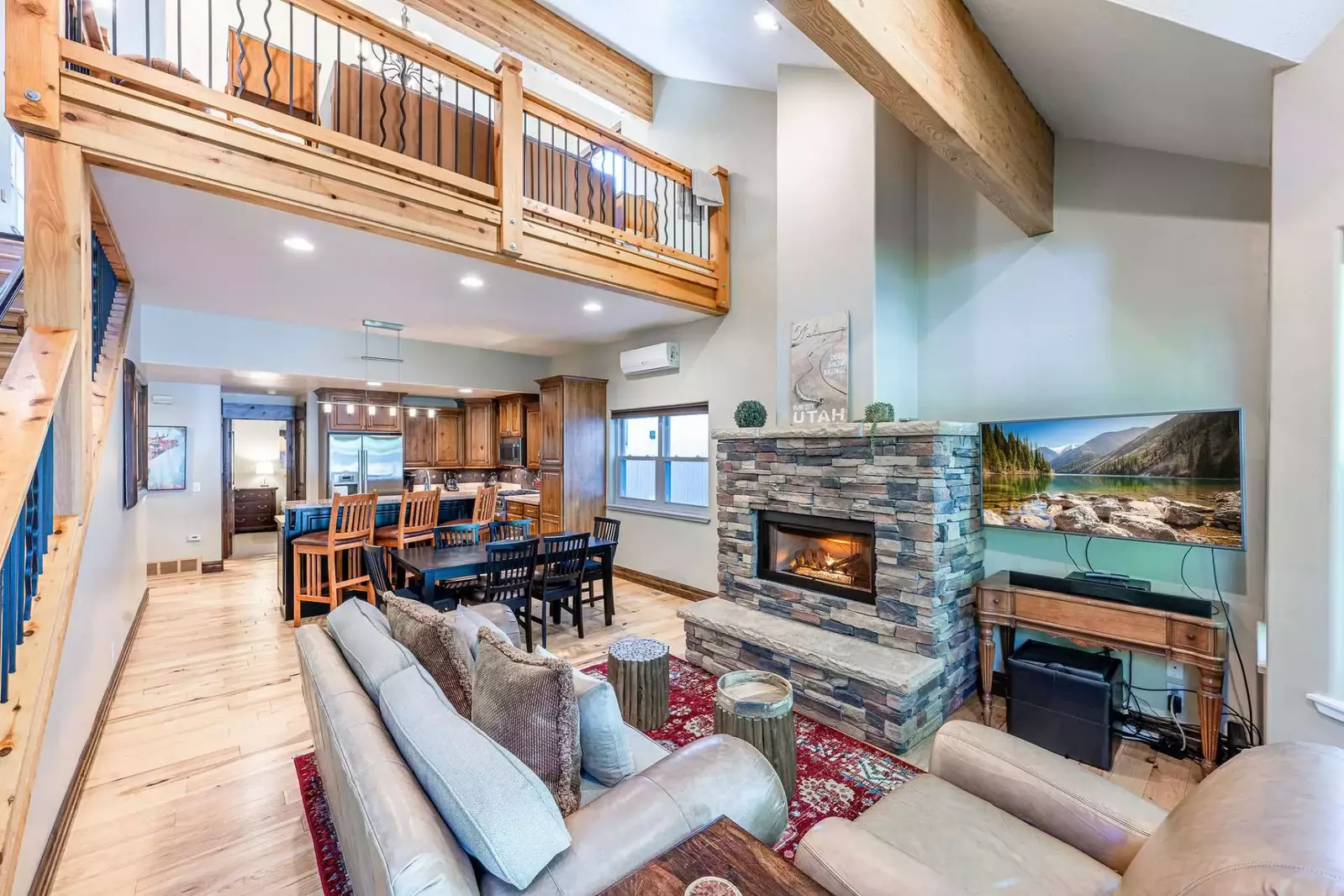 Valuted ceiling living room provides comfortable seating for gathering around the gas fireplace