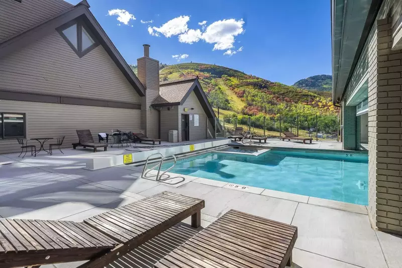 Outdoor pool just steps away from the home nestled against the mountain for extra privacy