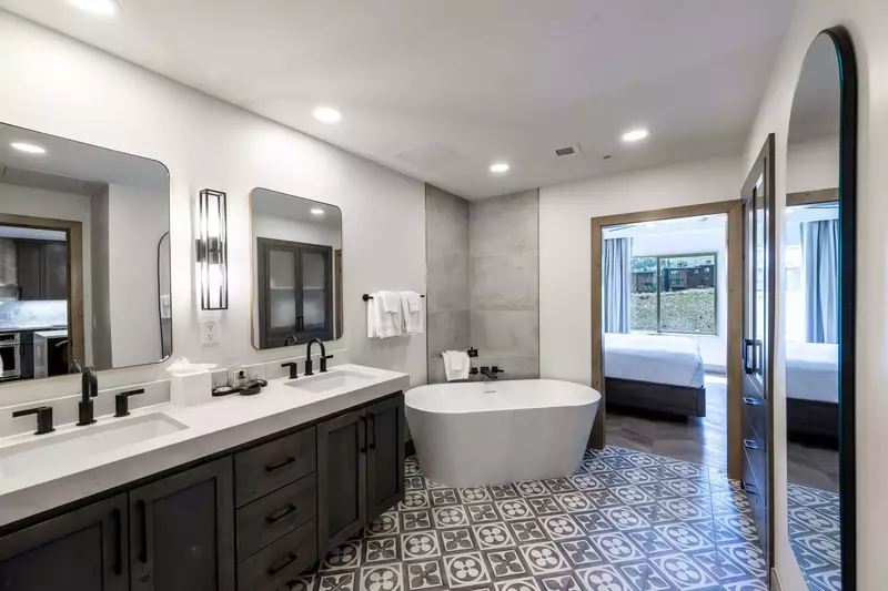 Relax in this gorgeous freestanding bath tub in the modern primary bathroom