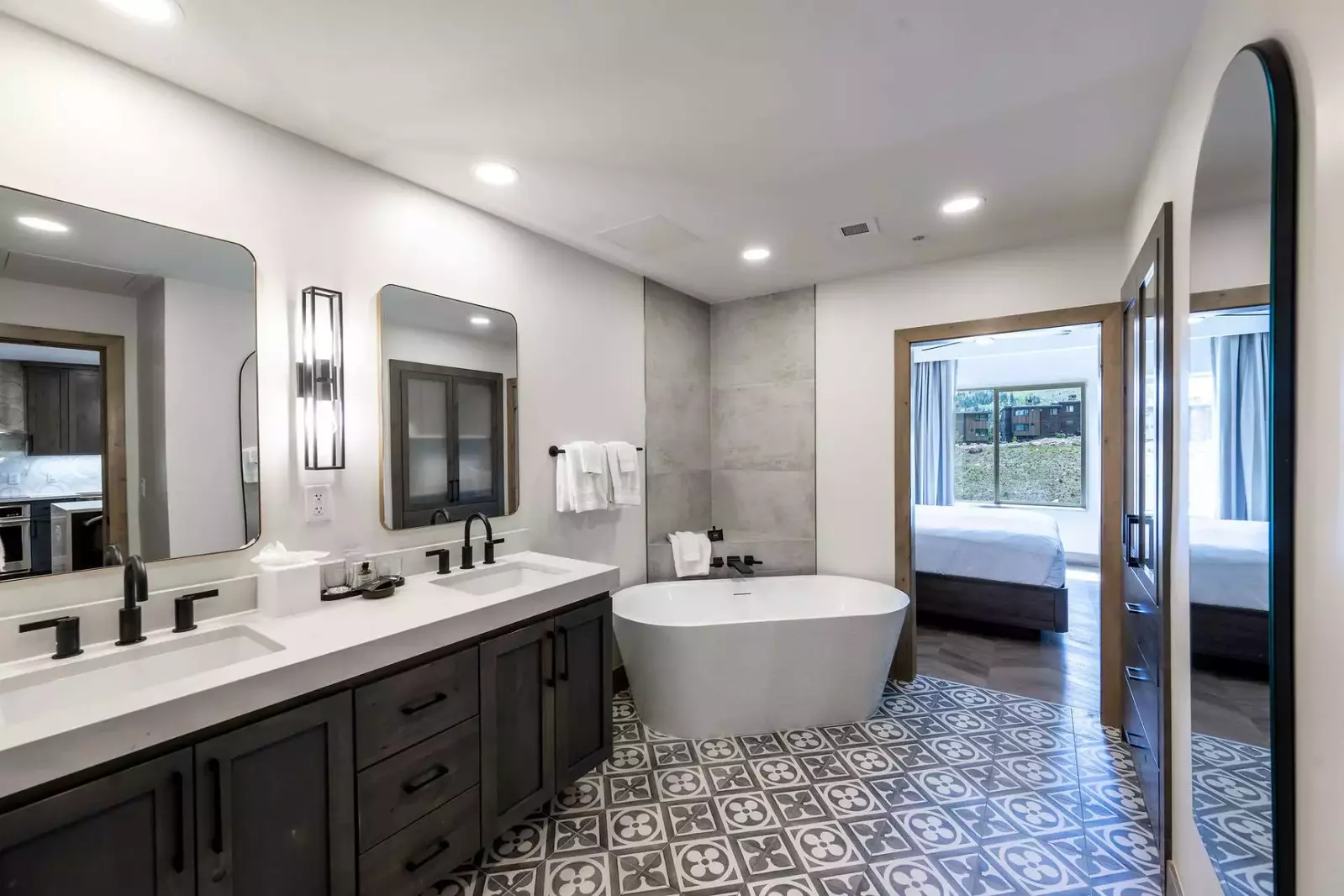 Relax in this gorgeous freestanding bath tub in the modern primary bathroom