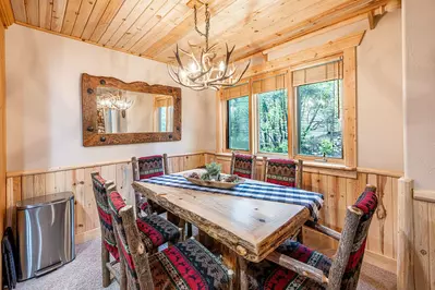 The adjoining dining room has a gorgeous dining room table that has seating for 6 guests.