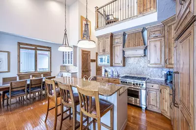 The primary kitchen features a breakfast bar, upgraded stainless steel Viking and Wolf appliances.