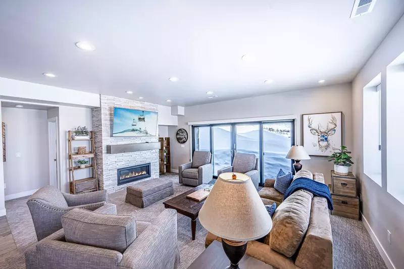 Walk out lounge level family room with fireplace, game table, HDTV, hot tub access