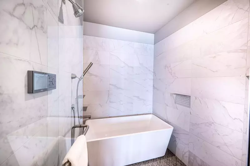The primary bathroom features an oversized walk in shower and oversized freestanding tub.