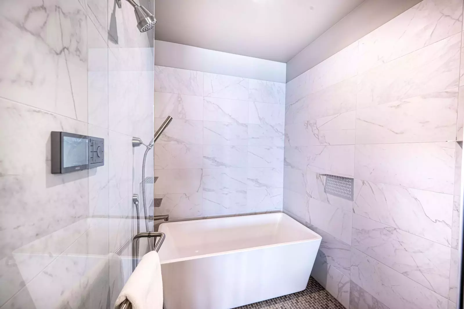 The primary bathroom features an oversized walk in shower and oversized freestanding tub.