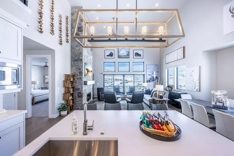 Open space living area infused with morning sunlight and views of the mountains