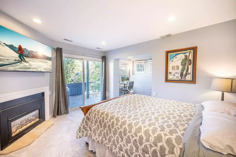 The lower level guest suite features a plush Queen bed & access to the private hot tub, HDTV, fireplace & separate office area