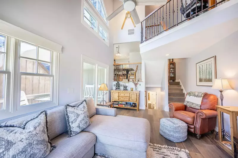 The warm and inviting family room has gorgeous views, vaulted ceiling new HDTV, new fireplace, leather  chair and comfortable upholstered L-shaped sof