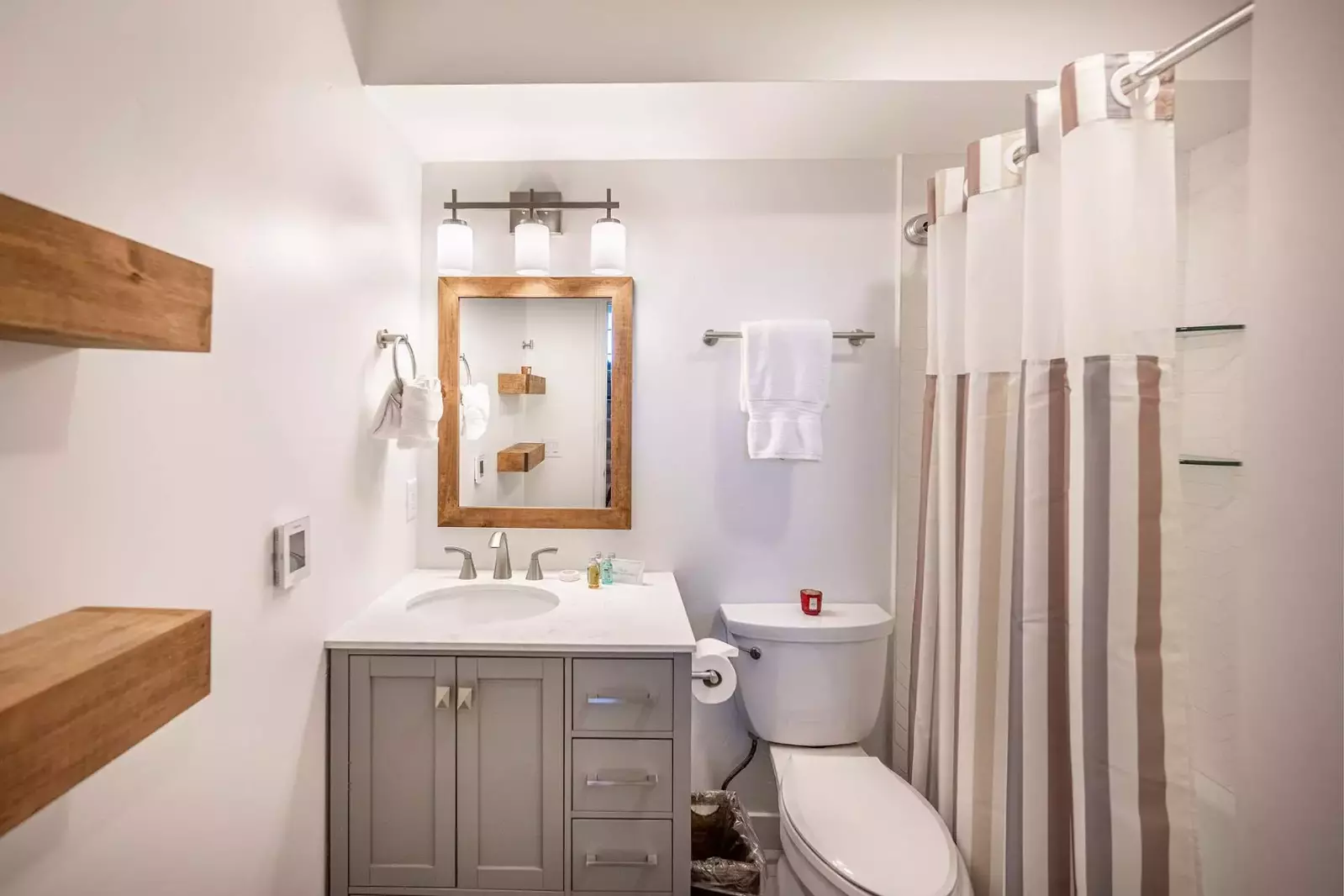 Located just outside the guest room is a bathroom. The middle level bathroom was updated in 2022 and features a new oversized vanity