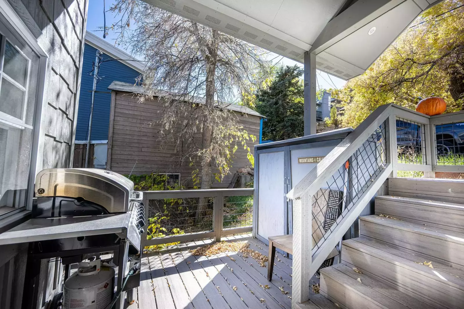 The gas grill is located on the front deck, just outside of the kitchen,