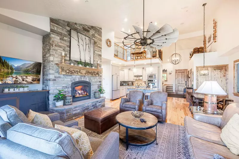 This spacious living room has vaulted ceilings, a large gas fireplace, and open floor plan to the kitchen.
