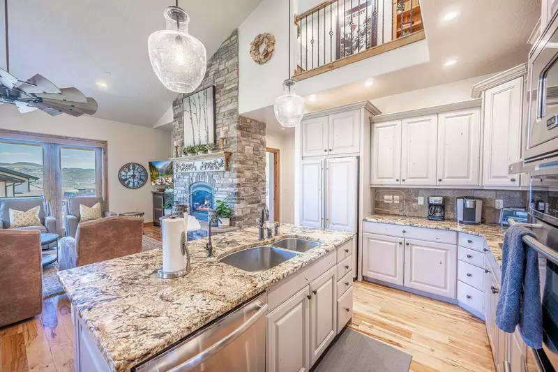 The kitchen is equipped with gourmet stainless steel appliances, granite countertops, and all the equipment you may need
