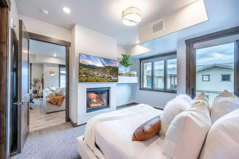 Located off the living room, the bright and cheery guest suite has a King bed, gas fireplace and oversized HDTV, new king sized bed, and queen sized d