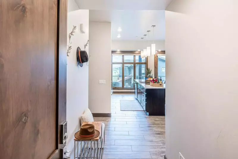 Convenient bench and shoe storage are featured in the large entryway