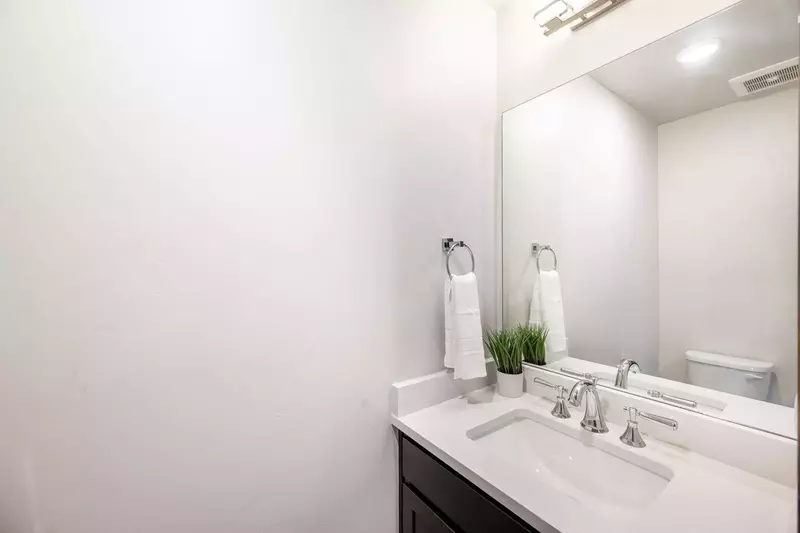 Guests will enjoy the half bathroom just off the entrance of the home