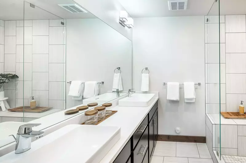 Double sinks are featured in the primary suite's bathroom and an oversized walk in shower