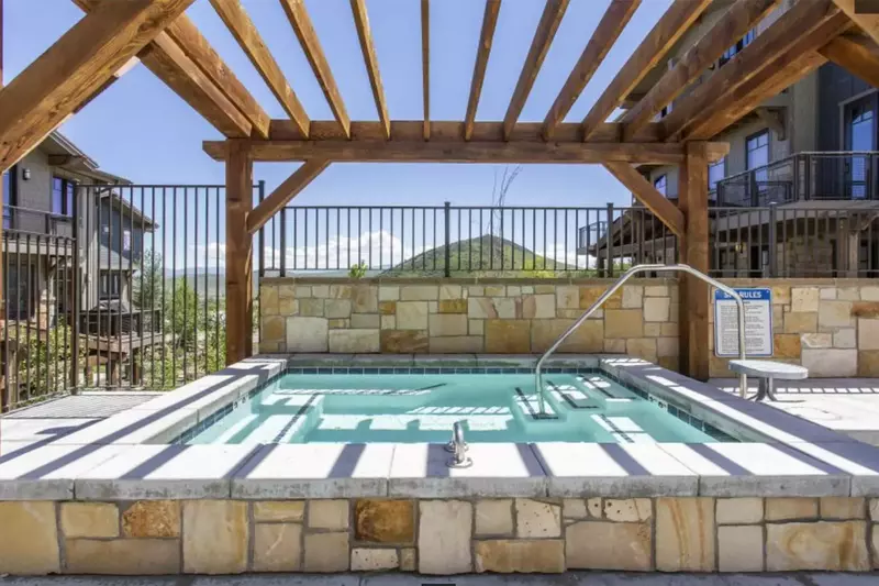 The communal hot tub is located at the clubhouse which is just steps from the home and is open year around