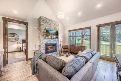 Massive windows throughout the main living area allow the outside in and welcome visitors with remarkable views of one of the most beautiful locations