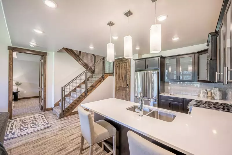 Gourmet kitchen features quartz counters, hardwood cupboards & stainless steel viking appliances (french door fridge, microwave, dishwasher, stove).