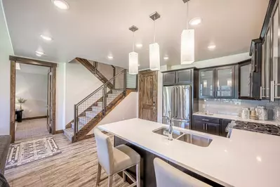 Gourmet kitchen features quartz counters, hardwood cupboards & stainless steel viking appliances (french door fridge, microwave, dishwasher, stove).