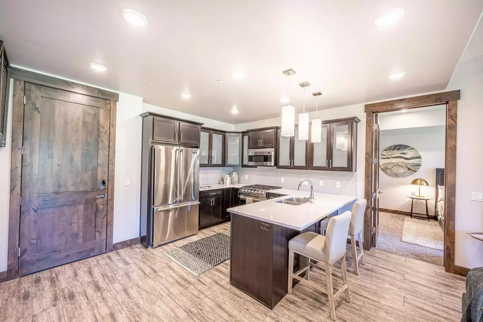The perfectly appointed kitchen boasts top of the line Viking appliances, striking quartz countertops and an abundance of prep space for entertaining.