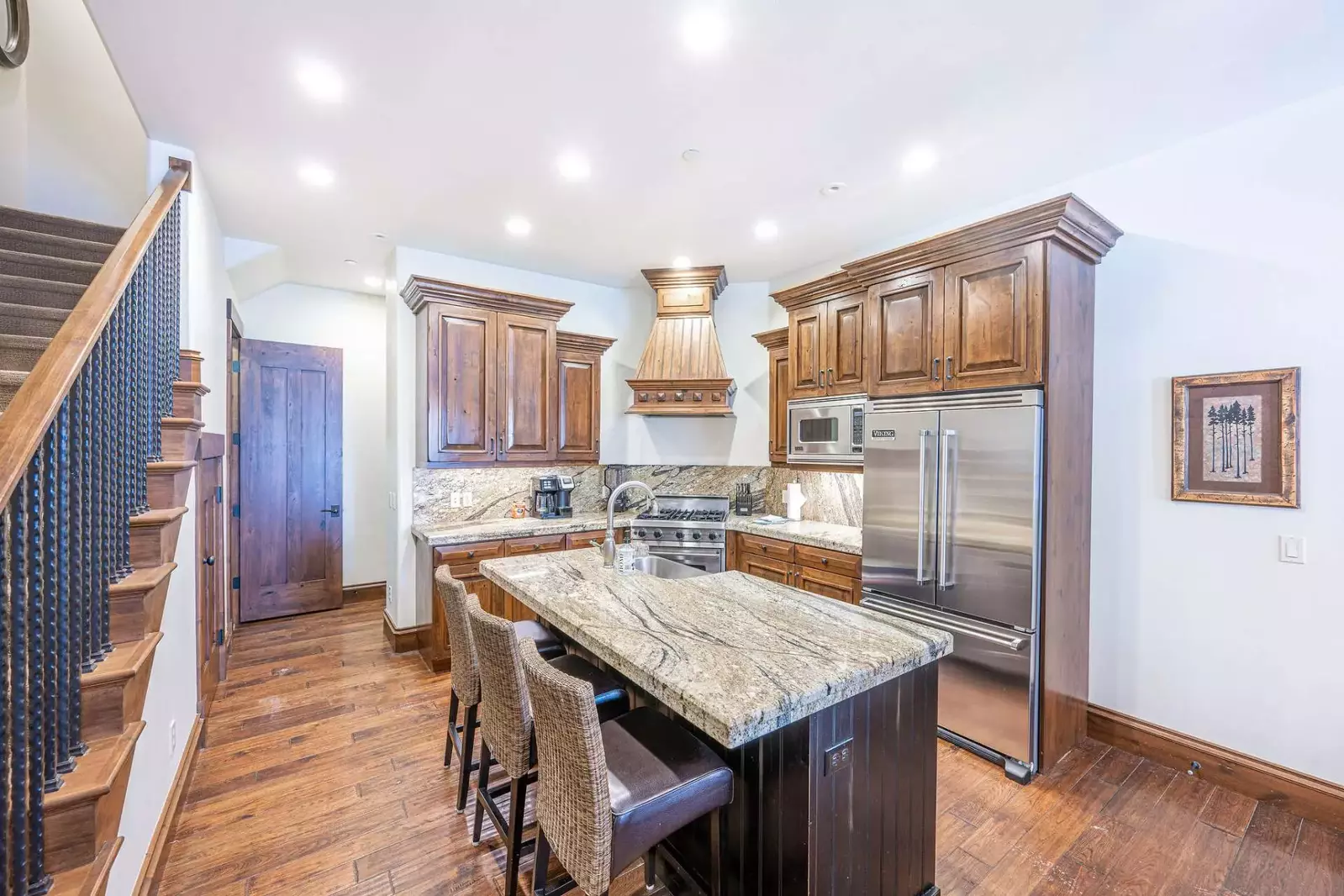 The Gourmet Kitchen boasts large Viking appliances and a large granite counter top island with ample space to prepare your meals