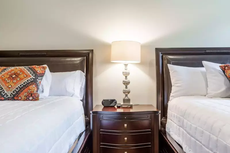 The second guest suite has a large shared nightstand and alarm clock so you don't miss a minute of your vacation.