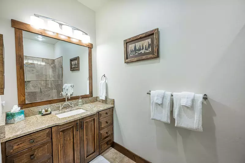 The primary bedroom's en suite bathroom boasts a luxury granite vanity with plenty of storage.